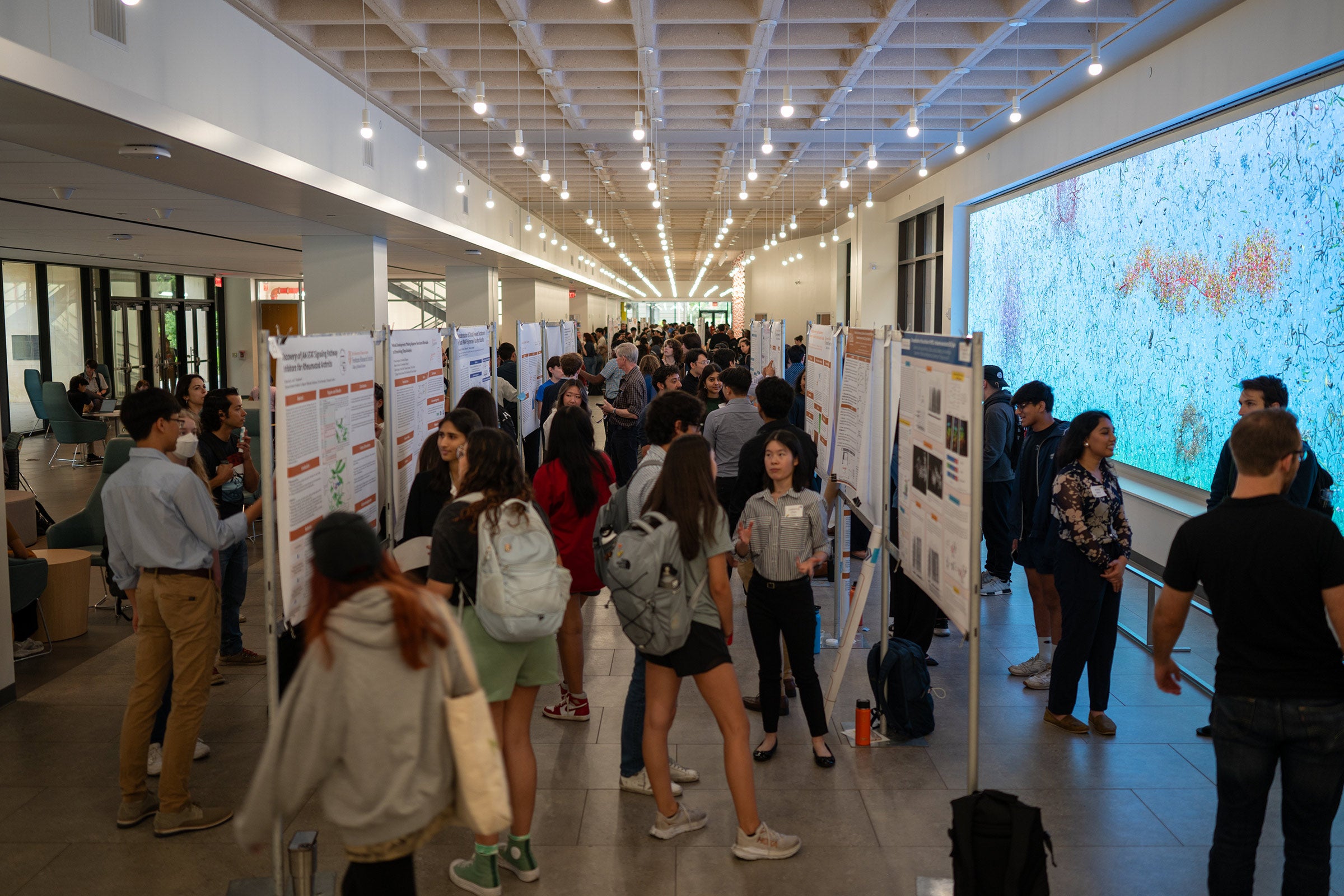 A photo of student presenters at a research poster forum