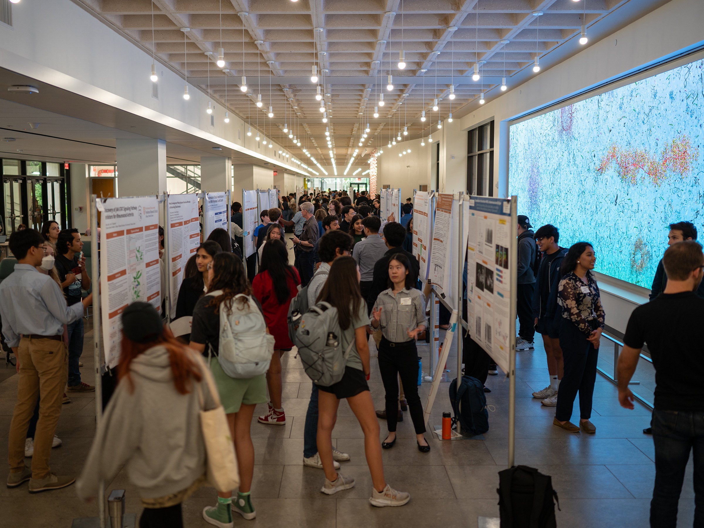 A photo of student presenters at a research poster forum